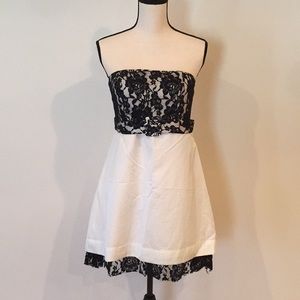 Black and white lace bodice belted strapless dress